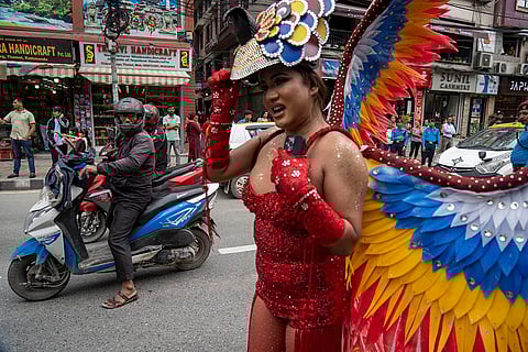 A participant poses for a photograph during pride parade, in Kathmandu